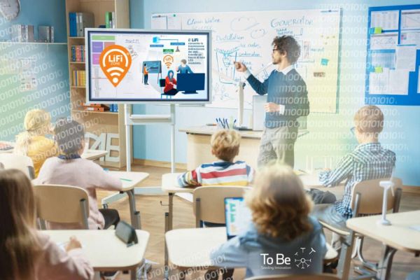 Elementary School Science Teacher Uses Interactive Digital Whiteboard to Show Classroom Full of Children how Software Programming works for Robotics. Science Class, Curious Kids Listening Attentively